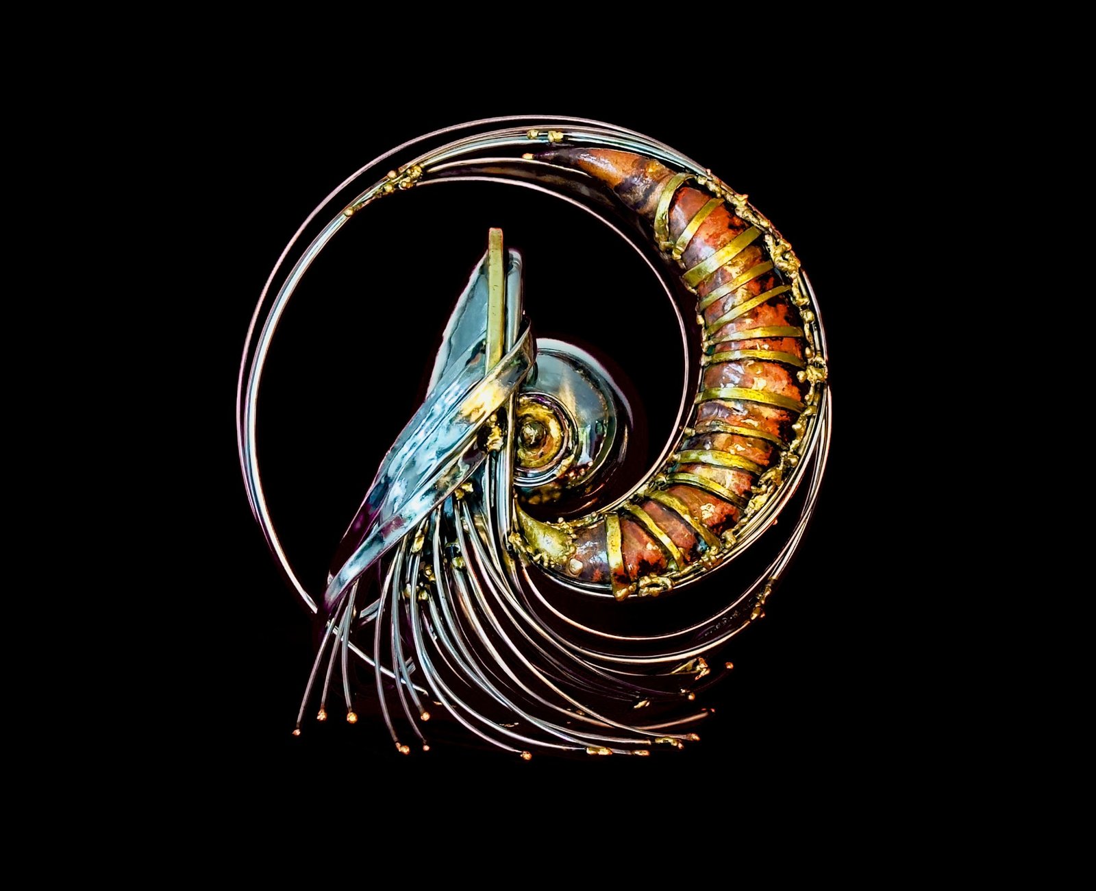 Cwtch: a copper horn wrapped in brass bands, spiralling inside rings